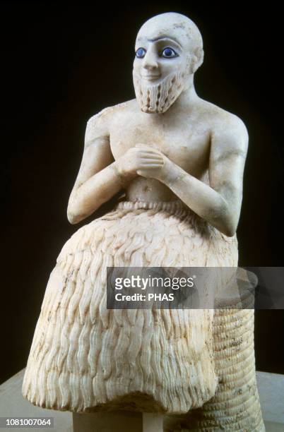 The statue of Ebih-II, superintendent of Mari. C. 2400 BC. Sumerian. It was found in the temple of Ishtar, Mary , Syria. Ebil-Il is seated on a...