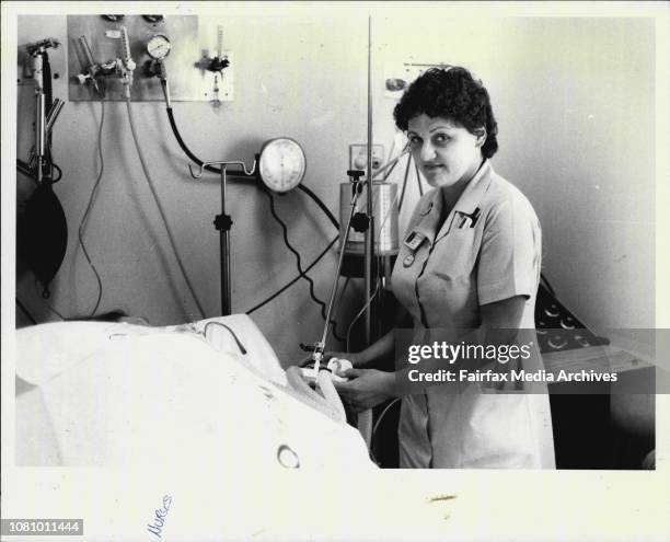 Registered nurse, Helen Kozak, working in the intensive care unit with a ventilator. October 18. 1984. .