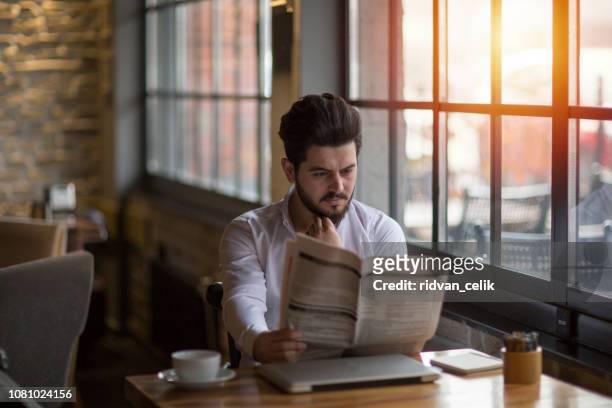 businessman having coffee with newspaper - hermanus stock pictures, royalty-free photos & images