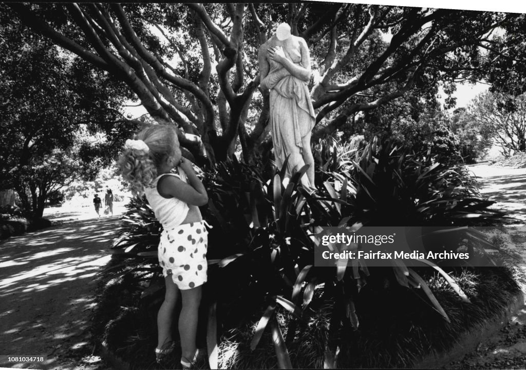 A statue which has been in the Botanical gardens since 1890 which had its head knocked off last night. Jodie Piddington aged 2 looking on.