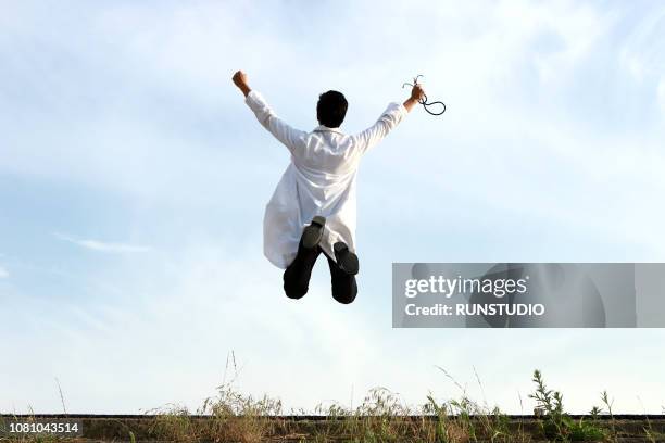 doctor jumping - doctor leaping stock pictures, royalty-free photos & images