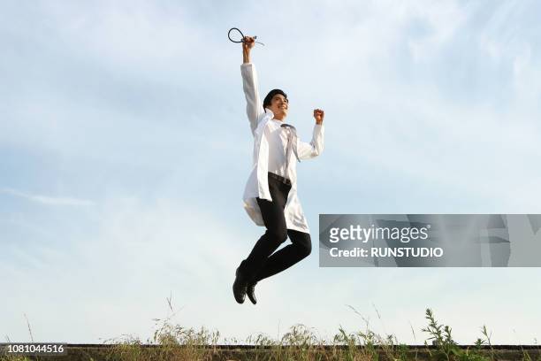 doctor jumping up - doctor leaping stock pictures, royalty-free photos & images