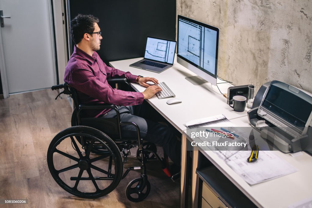 Man with differing abilities working in the office