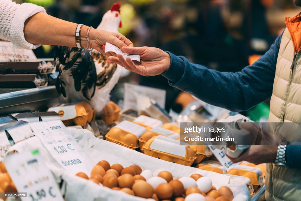 Customer buying organic eggs at the farmer's market