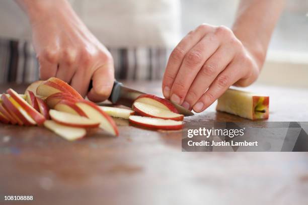 girl chopping apple - surface preparation stock pictures, royalty-free photos & images