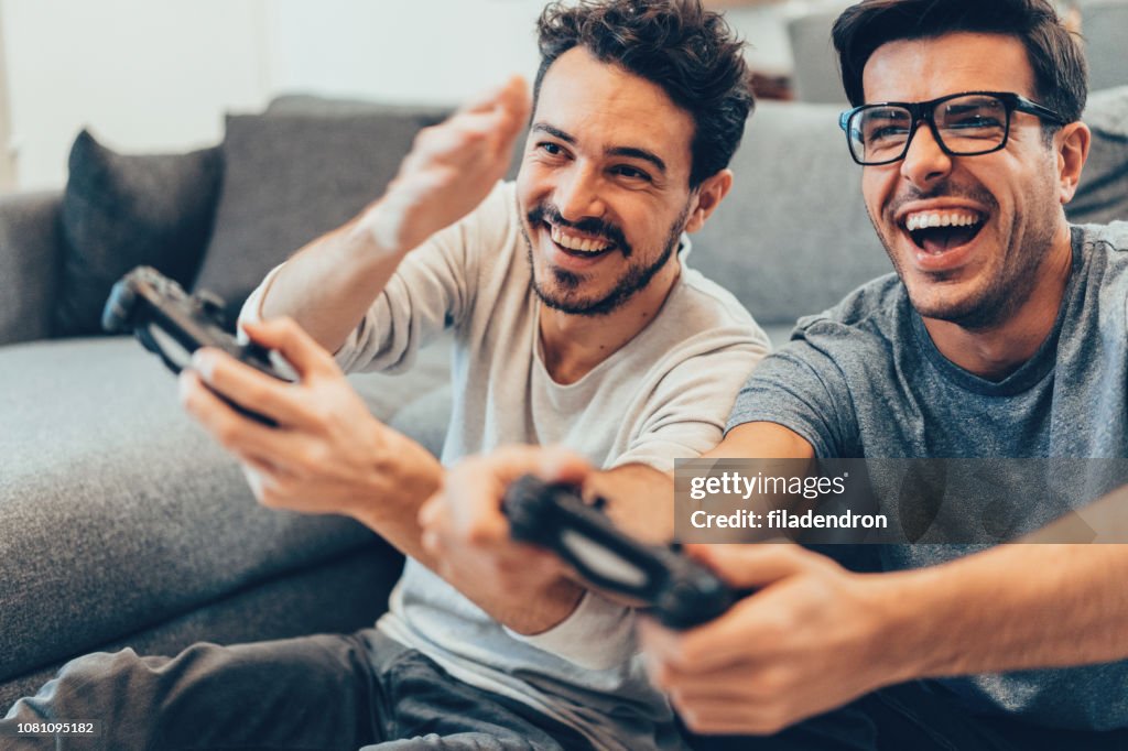 Excited friends playing video games