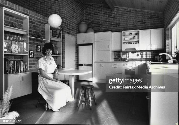 Pics taken?? of house in Berkeley Street Peakhurst.Lesley Dean at the table which attached to the wall of her low-maintenance kitchen. July 9, 1987. .