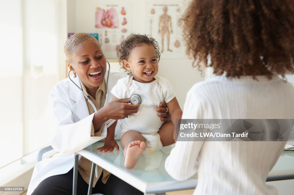 Doctor listening to baby's breathing with stethoscope