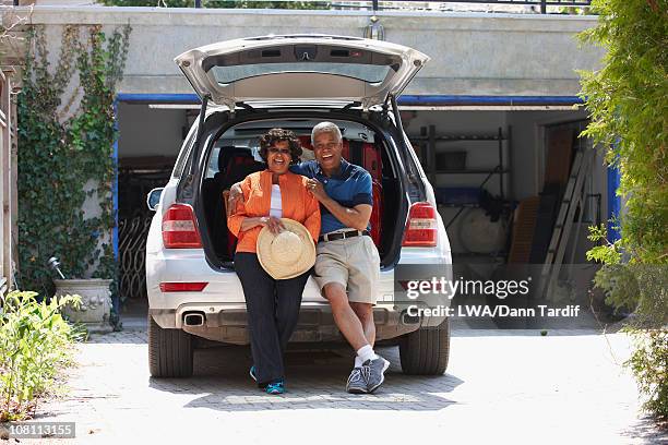 black couple loading car for vacation - old garage at home stock pictures, royalty-free photos & images