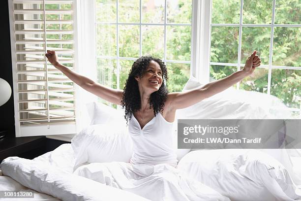 black woman waking up in bed - seize the day bed stock pictures, royalty-free photos & images