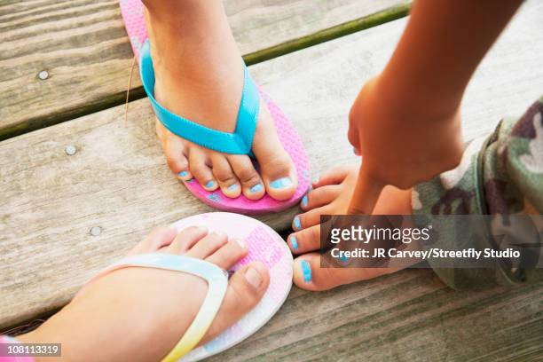 hispanic children touching feet - pointed foot stock pictures, royalty-free photos & images