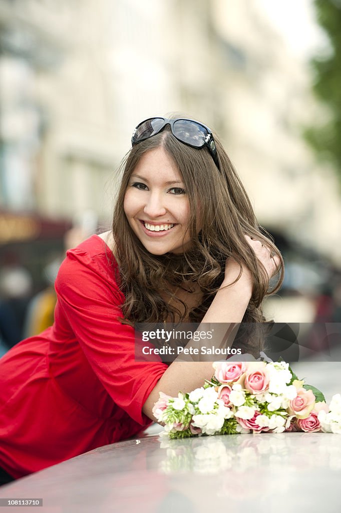 Smiling Caucasian woman holding bouquet