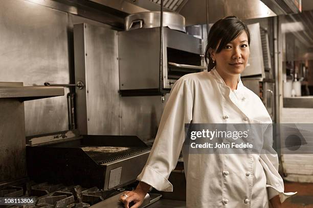 chinese chef standing in commercial kitchen - chef vs chef stock pictures, royalty-free photos & images