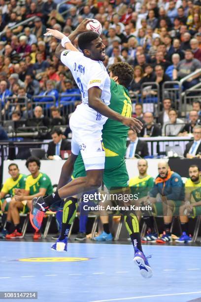 Dika Mem of France is challenged by Jose Toledo of Brazil during the Group A match of 26th IHF Men's World Championship between Brazil and France at...