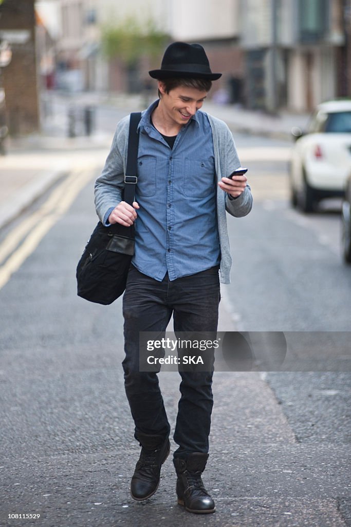 Young male looking at mobile phone