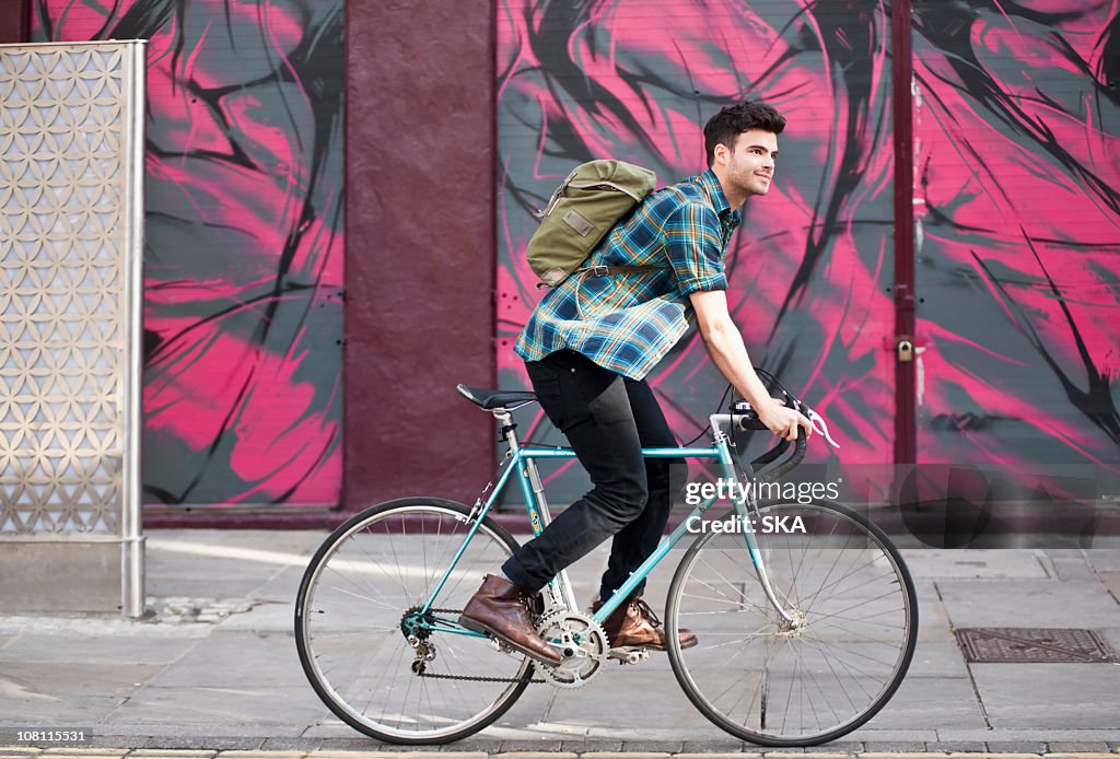 Male riding cycle, smiling