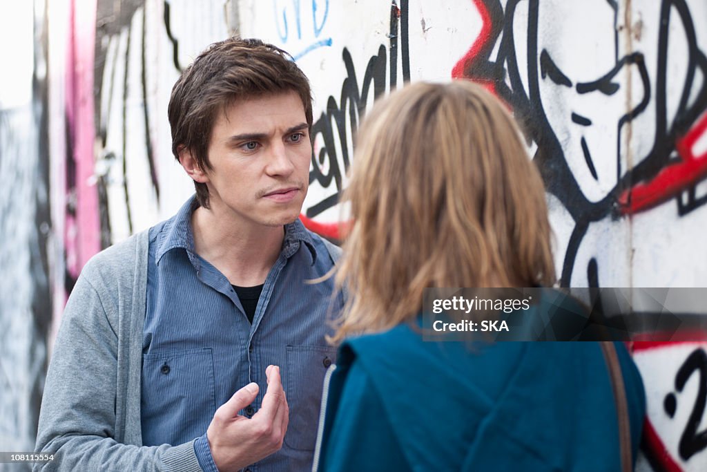 Young couple arguing in street