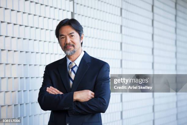 serious japanese businessman with arms crossed, portrait - portrait business japanese stock pictures, royalty-free photos & images