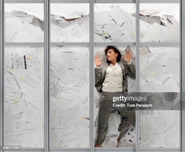 mixed race businesswoman drowning in paperwork - drunkna bildbanksfoton och bilder