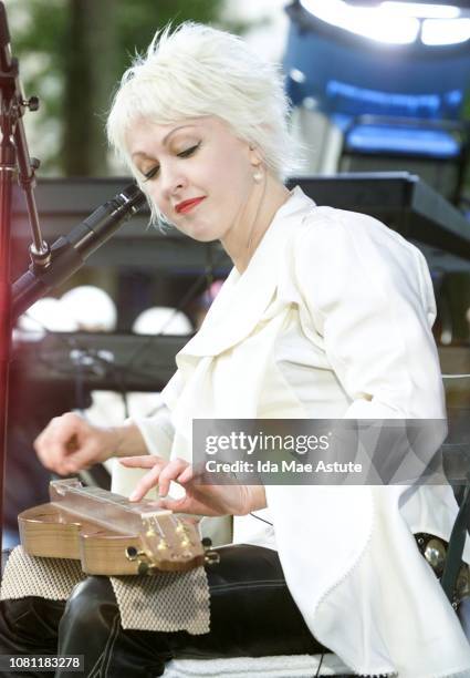 Cyndi Lauper plays the dulcimer performing on ABC's 'Good Morning America' summer concert series in Bryant Park, 06/07/02.