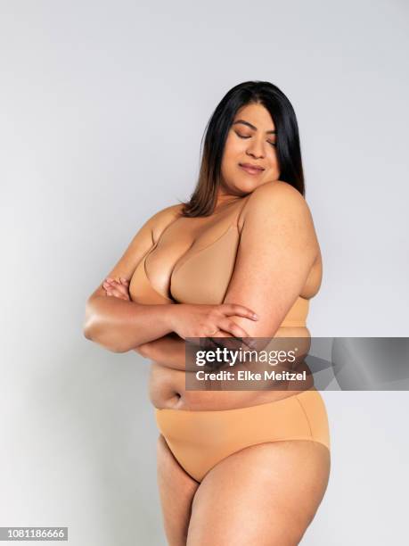 woman in underwear hugging herself - big fat women stock pictures, royalty-free photos & images