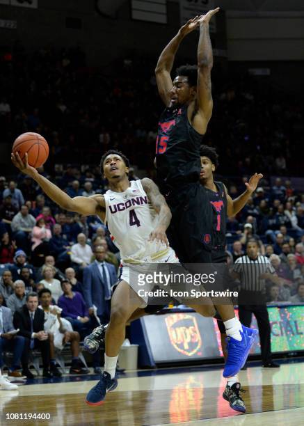 UConn Huskies guard Jalen Adams is fouled as he shoots by Southern Methodist Mustangs forward Isiaha Mike during the game as the Southern Methodist...