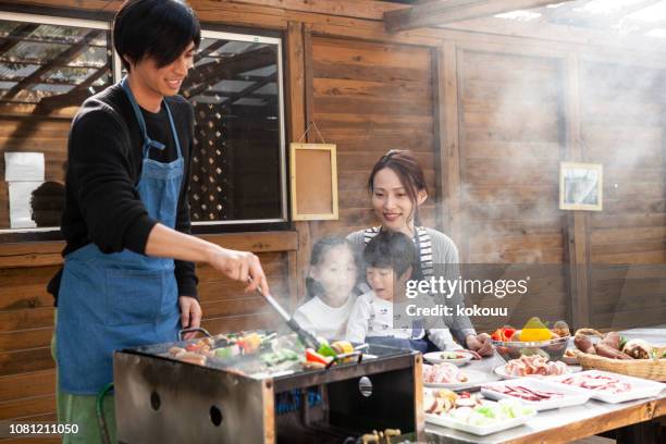 children waiting for the ingredients to burn - bbq smoker stock pictures, royalty-free photos & images