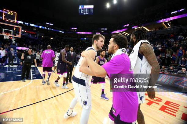 Luka Doncic of the Dallas Mavericks and Tyus Jones of the Minnesota Timberwolves hug after the game on January 11, 2019 at Target Center in...