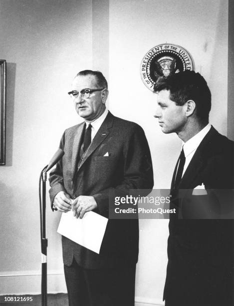 President Lyndon Johnson speaks into a microphone about United States Attorney General Robert F. Kennedy , who had just returned from a tour of South...