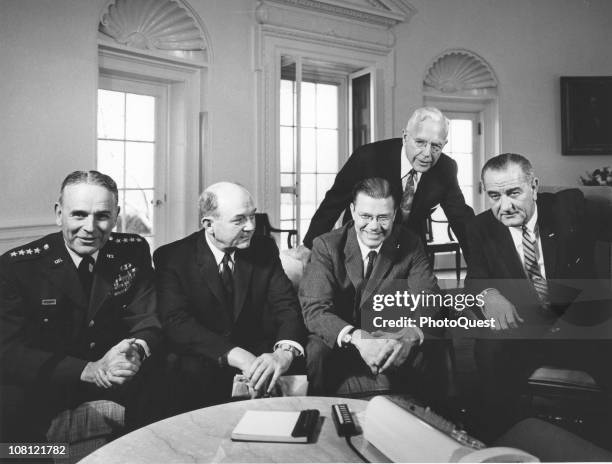 President Lyndon Johnson poses in the White House's Oval Office with Chairman of the Joint Chiefs of Staff General Maxwell D. Taylor , Secretary of...