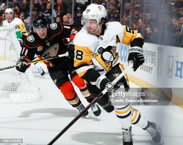 Kris Letang of the Pittsburgh Penguins skates against Daniel Sprong of the Anaheim Ducks during the third period of the game at Honda Center on...