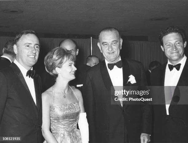 President Lyndon Johnson poses with American actress and singer Florence Henderson and comedy duo Dick Martin and Dan Rowan of television show 'Rowan...