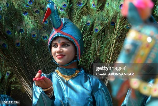 An Indian student performs a peacock dance during celebrations for Pongal, the Tamil harvest festival, at a college in Chennai on January 12, 2019.