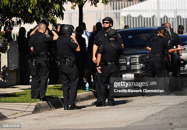 Los Angeles police gather at the police command post after a school shooting at Gardena High School on January 18, 2011 in Gardena, California....