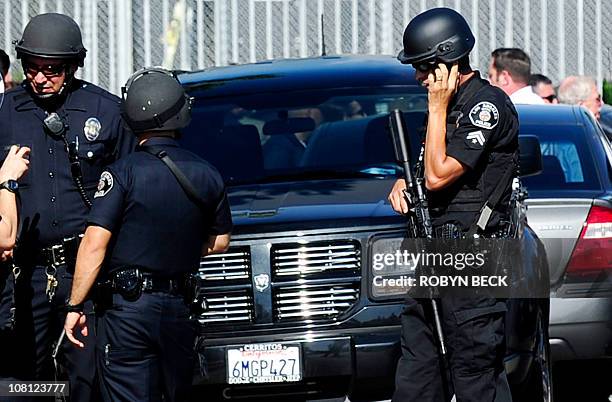 Police and sherriffs deputies maintain a command post outside Gardena High School in Los Angeles January 18, 2010 where two students suffered gunshot...