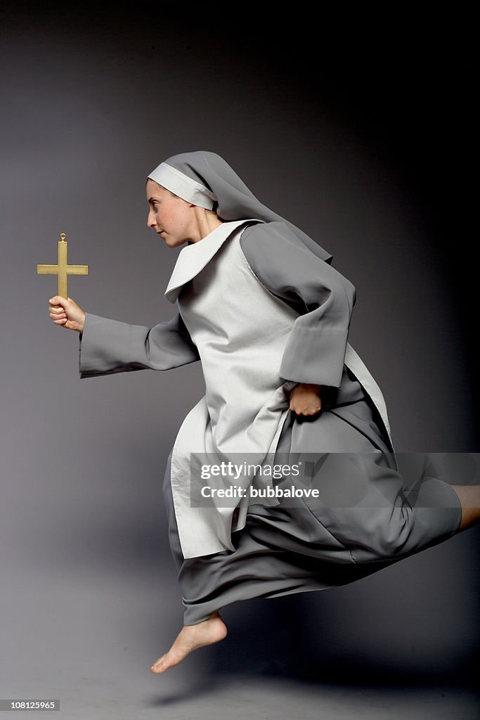 Nun Holding Cross and Running, On Gray Background