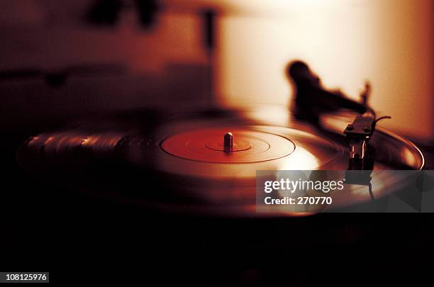 vinyl playing on record player - dj club stock pictures, royalty-free photos & images