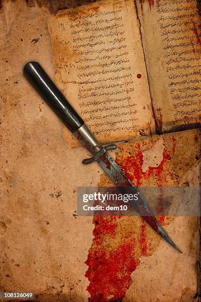 blood covered knife on ancient antique paper and book - bloody knife stockfoto's en -beelden