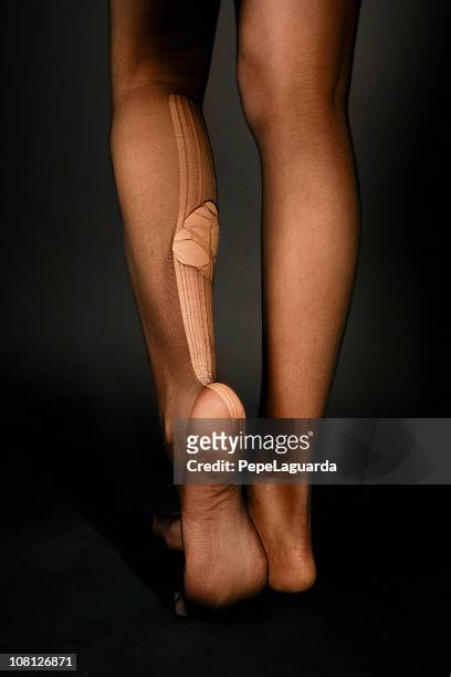 back of young woman's legs with huge run in stockings - strumpbyxor bildbanksfoton och bilder