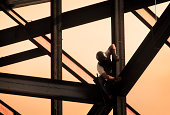 Construction Worker on High Rise Frame of Building