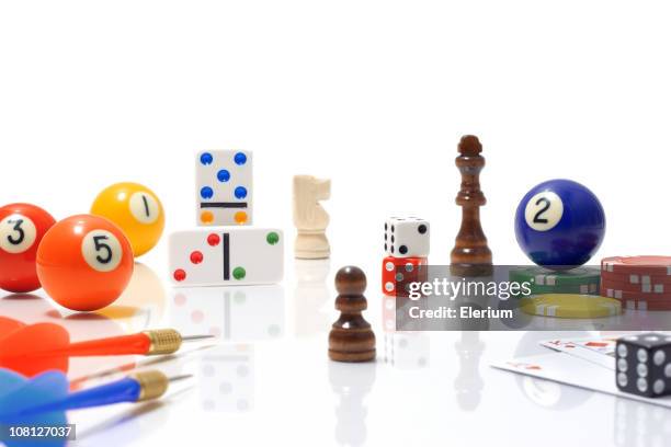 variety of game pieces on white background - billiard ball game stock pictures, royalty-free photos & images