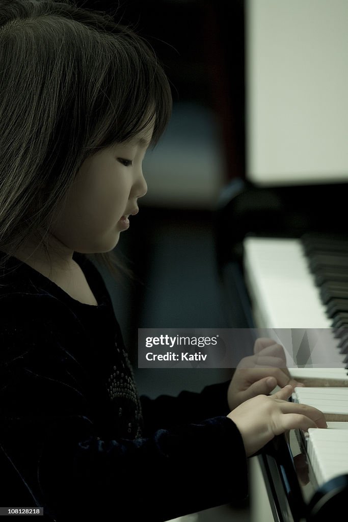 Young girl playing a piano