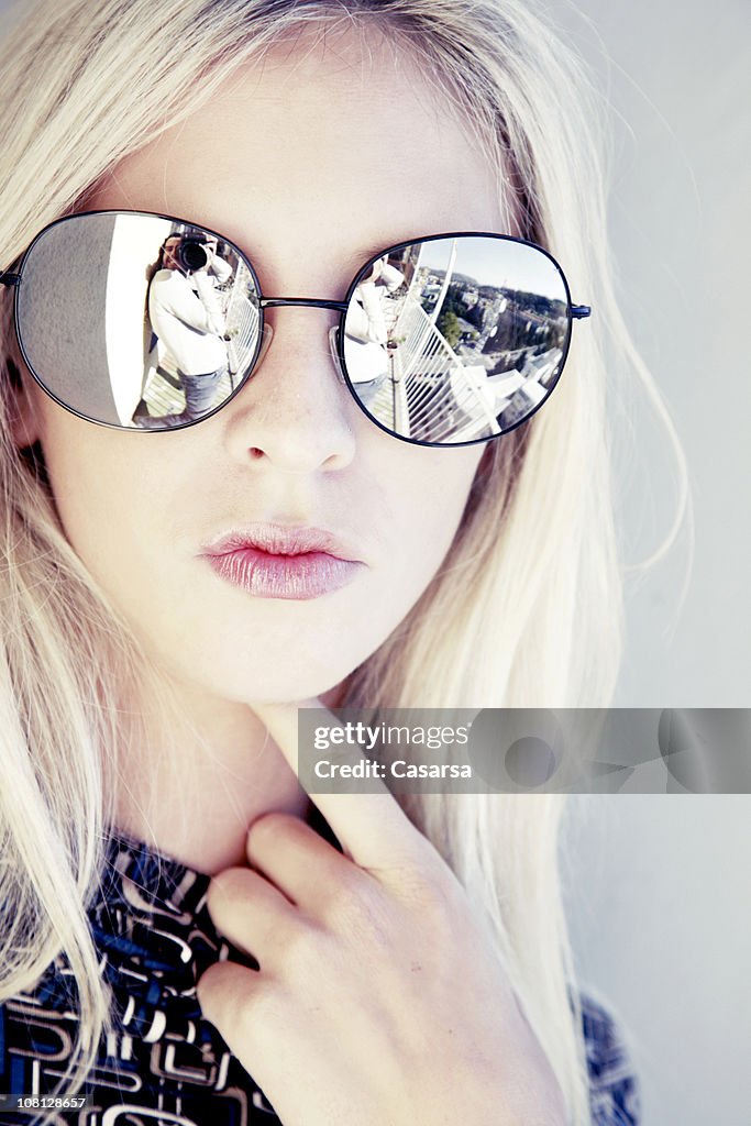 Reflection of Photographer in Young Woman's Sunglasses
