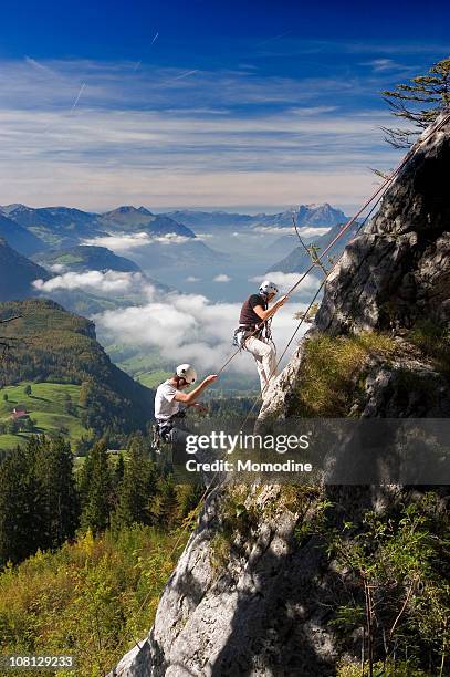 rock climbers - rappelling stock pictures, royalty-free photos & images