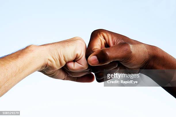 black and white fists touching - respect stock pictures, royalty-free photos & images