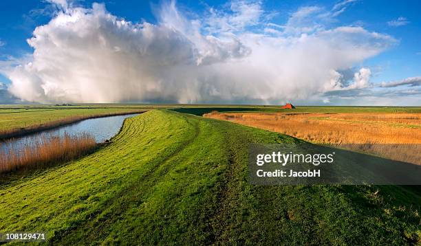 dyke and clouds - levee stock pictures, royalty-free photos & images