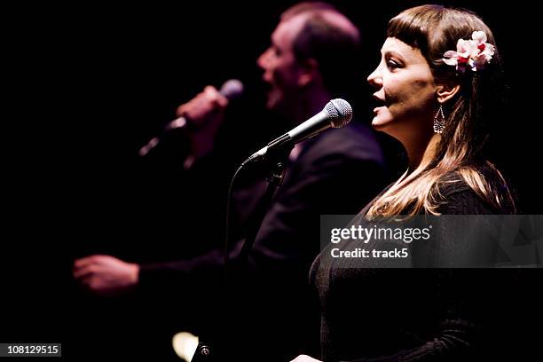 duet between a male and female vocalist live on stage - nattklubbssångare bildbanksfoton och bilder