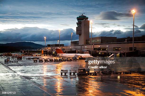 rainy evening at airport terminal and hangar - jet tarmac stock pictures, royalty-free photos & images