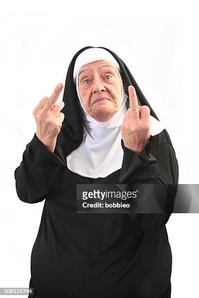 senior nun giving two middle finger gestures, isolated on white - nun outfit stock pictures, royalty-free photos & images