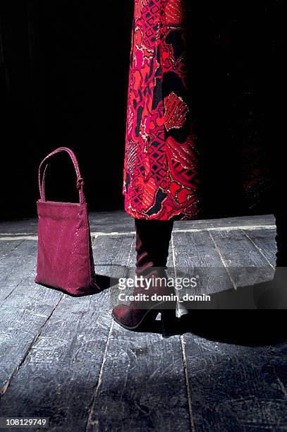 woman's leg with bag and boots on wooden floor - purple boot stock pictures, royalty-free photos & images
